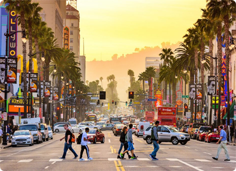 People walking across street in city